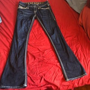 Rock Revival’s bootcut Adorna jeans with embellished pockets, size 27.
